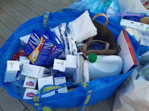 Zdjęcie torby wypełnionej lekami na przeziębienie oraz środkami opatrunkowymi.