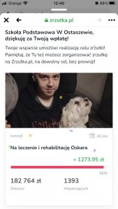 Zdjęcie ekranu telefonu, na którym wyświetlona została strona zrzutka.pl z informacją, że Szkoła Podstawowa w Ostaszewie dokonała wpłaty na leczenie i rehabilitację Oskara. Na stronie umieszczono zdjęcie Oskara oraz napis Twoje wsparcie umożliwi realizację celu zrzutki! Pamiętaj, że Ty też możesz organozować zrzutkę na Zrzutka.pl, na dowolny cel, bez prowizji.
