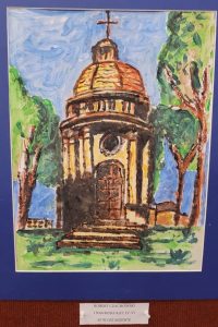 Zdjęcie nagrodzonej w konkursie plastycznym pracy naszego ucznia Roberta Czachowskiego. Praca przedstawiająca kapliczkę otoczoną drzeami oprawiono w niebieskie paspartu a pod spodem przyczepiono karteczkę: "Robert Czachowski I NAGRODA KAT. IV-VI SP W OSTASZEWIE.