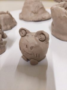 Zdjęcie figurki kotka wykonanej z gliny podczas warsztatów.