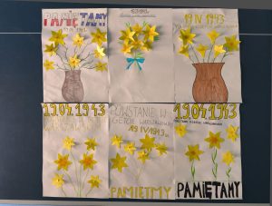 Zestaw kilku plakatów wykonanych przez uczniów, przedstawiających żonkile w wazonach i kompozycjach, z hasłami „Pamiętamy” oraz datą rocznicy.