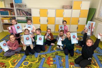 Uczniowie klas I–III prezentują materiały edukacyjne i pomoce do nauki pierwszej pomocy otrzymane w programie.